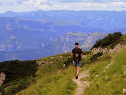 man walks along the path on the mountain