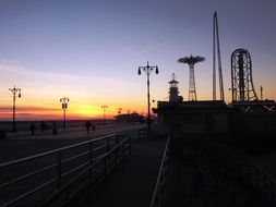 orange twilight over a theme park in new york