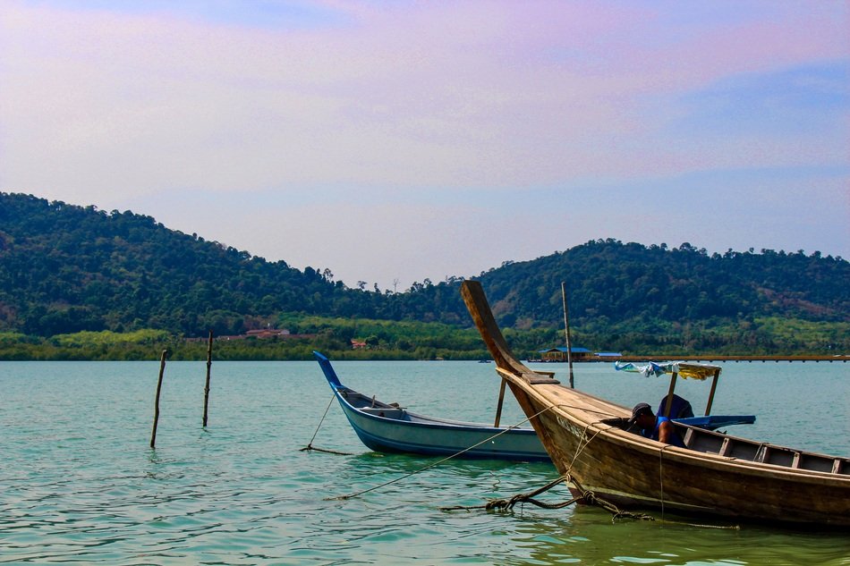 Boats on the green and blue water of the beautiful lake in Malaysia
