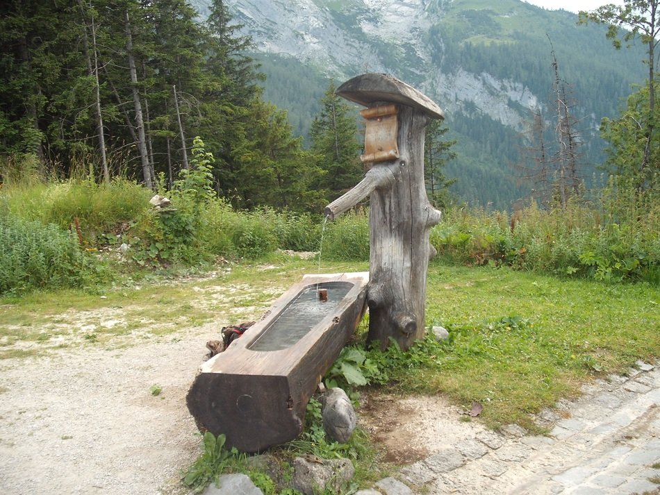 wooden water source in the alps