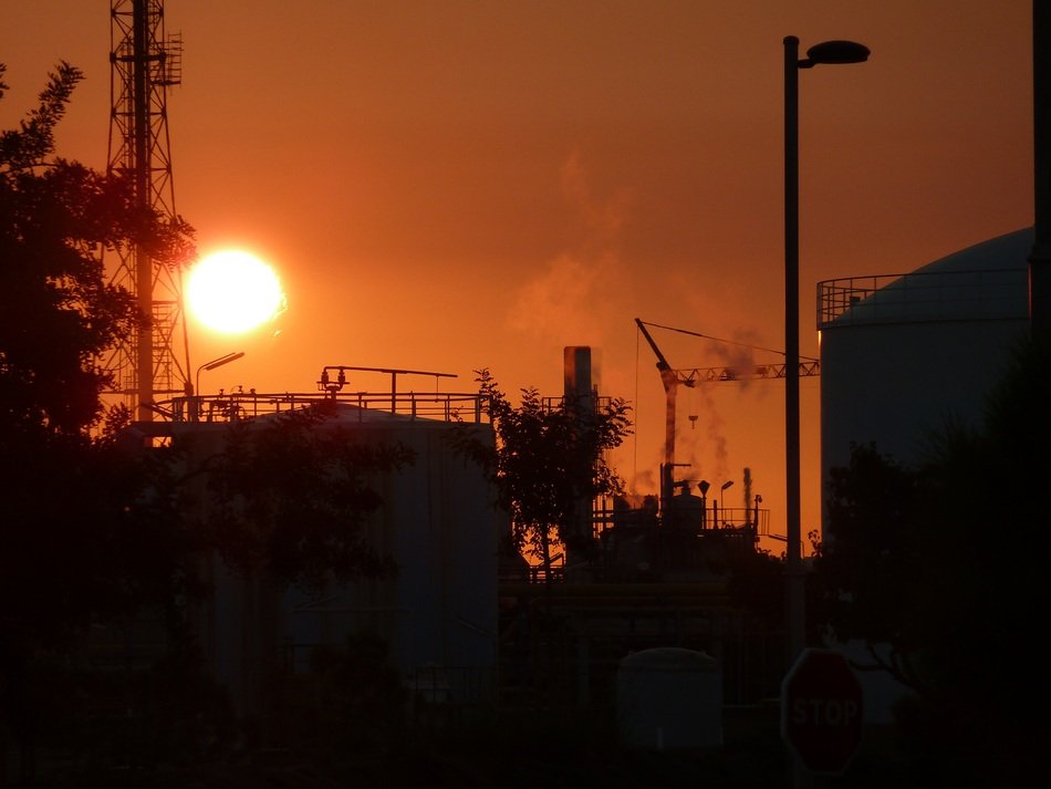 red Sun over refinery factory