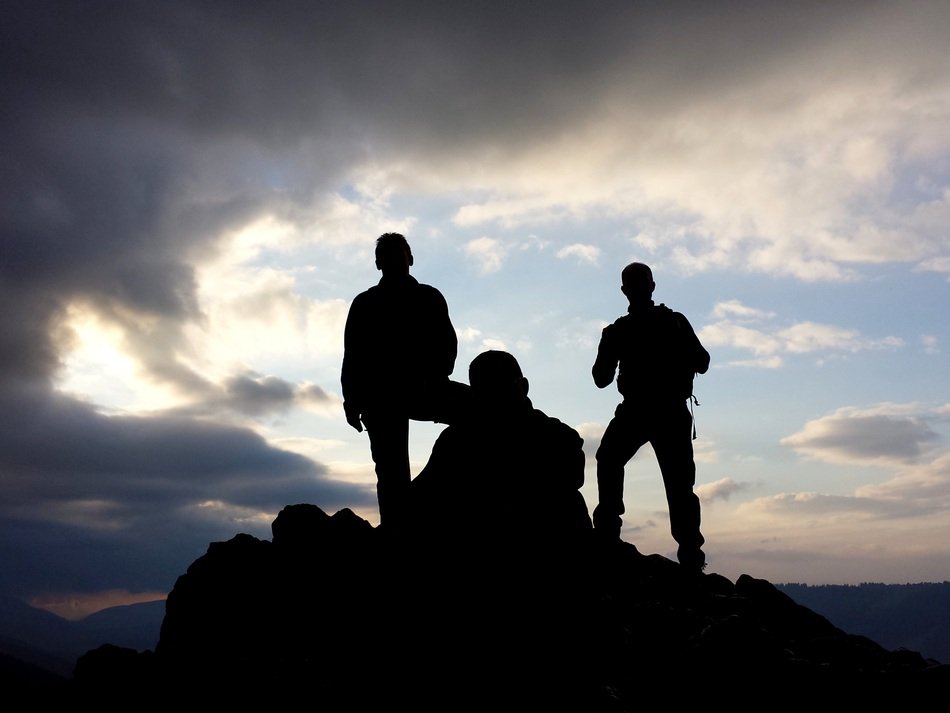 silhouettes of people on the mountain