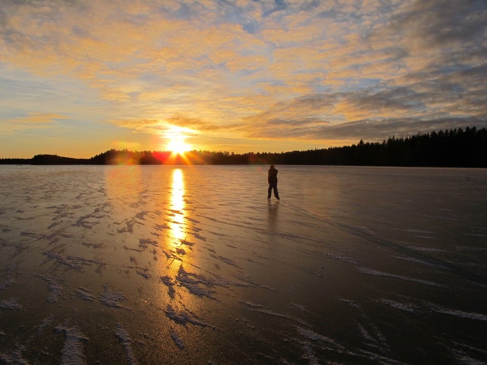 man on ice at sunset