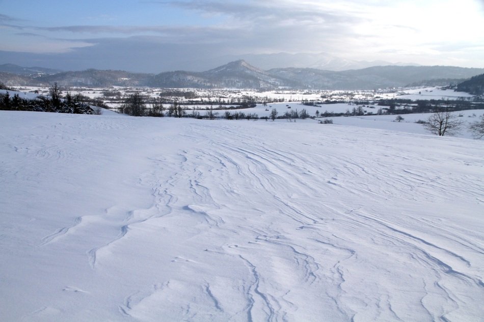 huge snow field in front of mountains