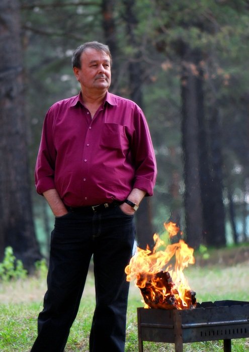 the man in the crimson shirt by the fire