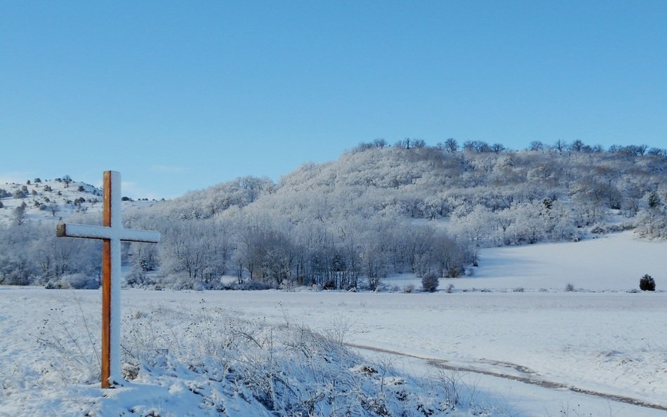 Landscape of cross on a field in winter