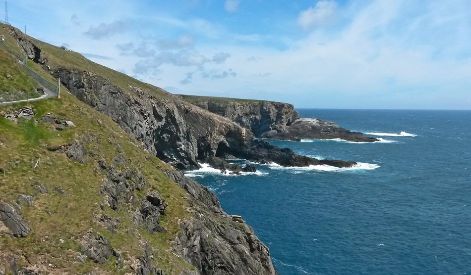 Beautiful mizen head, green Rocky Coast at deep blue sea, Uk, Ireland