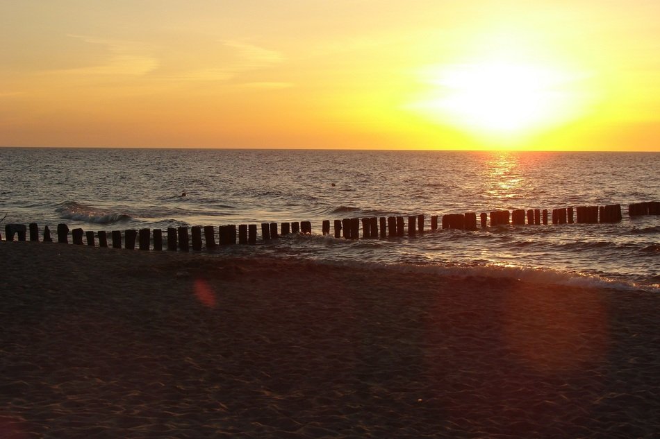 breakwater on the Baltic sea in the rays of a sunset