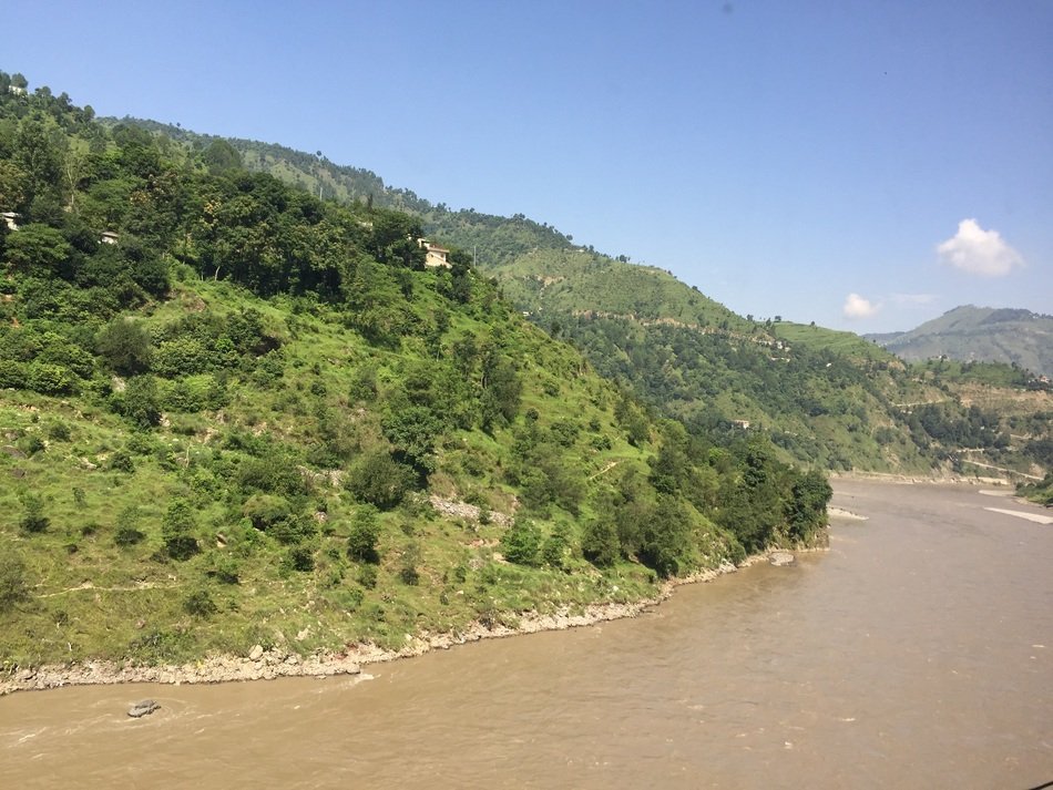 Landscape of the river near the green mountain