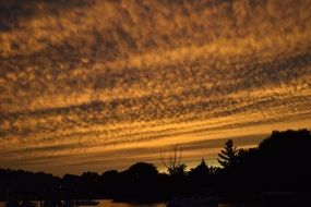 Beautiful landscape with the silhouettes under beautiful and golden sunset