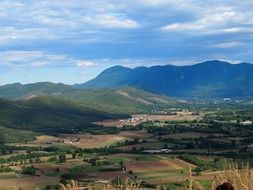 panoramic view of hilly landscapes in light and shade