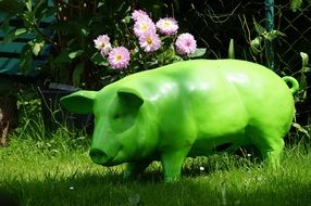 green pig sculpture in the garden