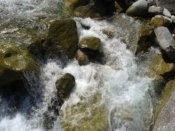 spray of mountain river under the bright sun