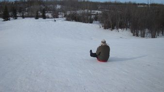 man rides on a sleigh