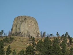 distant view of devil's tower basalt mountain
