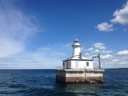 lighthouse on the water on a sunny day