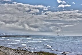 beach near the ocean under white clouds in spain