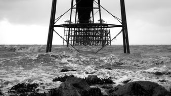 Pier in sea at Coast, black and white