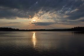 sunny path on the surface of the lake at sunset