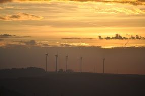 golden sky over wind turbines