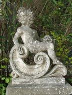 sitting child boy, stone sculpture outdoor, Italy, Tuscany