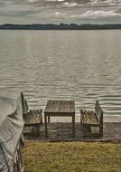 table and benches by the lake