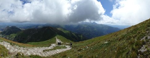 Panoramic landscape of white large clouds over high Tatras mountains