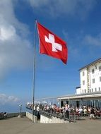 red flag with a white cross near the hotel