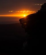 Cliff on the background of the sunset
