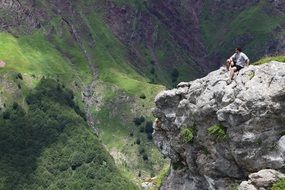 man on top of a rock cliff in the pyrenees