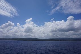 white clouds over a big blue lake