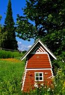 figurine in the form of a house on green grass