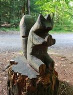 Wooden squirrel figurine in the forest