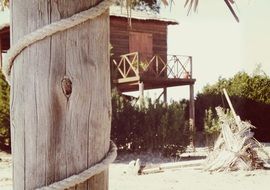 a pillar with a rope and a lifeguard on the beach