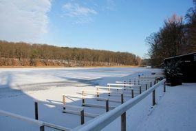 Beautiful, snowy, wintry lake among the colorful trees in Berlin, Germany