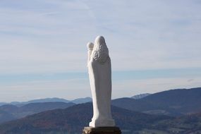 White statue of the Madonna on the mountain