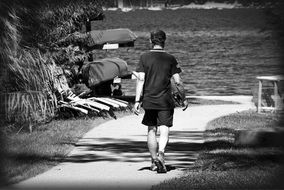 a man goes to the water black white photo