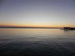 sunset on the horizon above the water