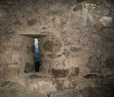 narrow window in a stone wall