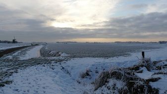 winter landscape and a mill in the distance
