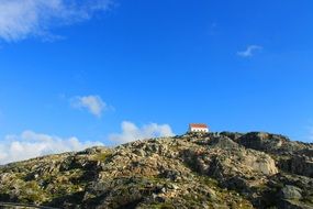 distant view of a house on a mountain peak in serra