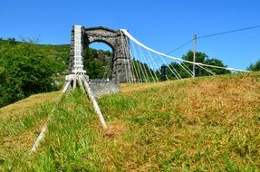 Beautiful stone bridge in colorful highlands and islands at blue sky background in Scotland