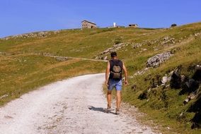 tourist on a dirt road in a mountainous area