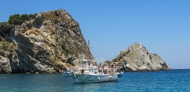 boat near the rocky coast of the small island of Skiathos