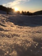 sparkling Snow Crystals at sunset close up