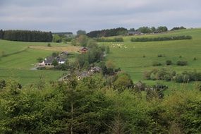 farm buildings on green meadow