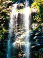 waterfall among the rocks in austria under the bright sun
