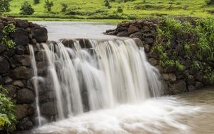 Milky waterfall among stones