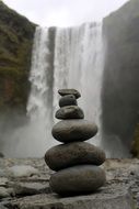 Cairn against the waterfall