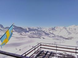flag on the mountain top in Alps